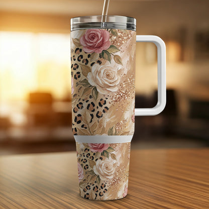 Floral and leopard print insulated tumbler with straw on wooden surface.