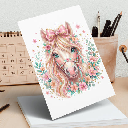 Pink unicorn with flowers and bow, with calendar in background.