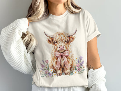 Watercolor Highland cow with pink bow surrounded by flowers.