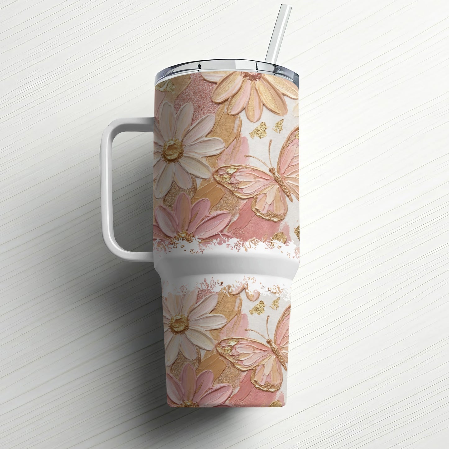 White tumbler with textured floral and butterfly design and a straw.
