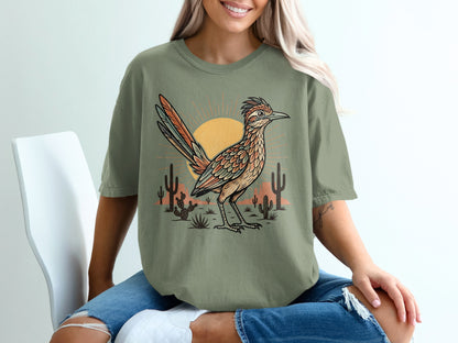 T-shirt with roadrunner, sun, and cacti desert scene graphic.
