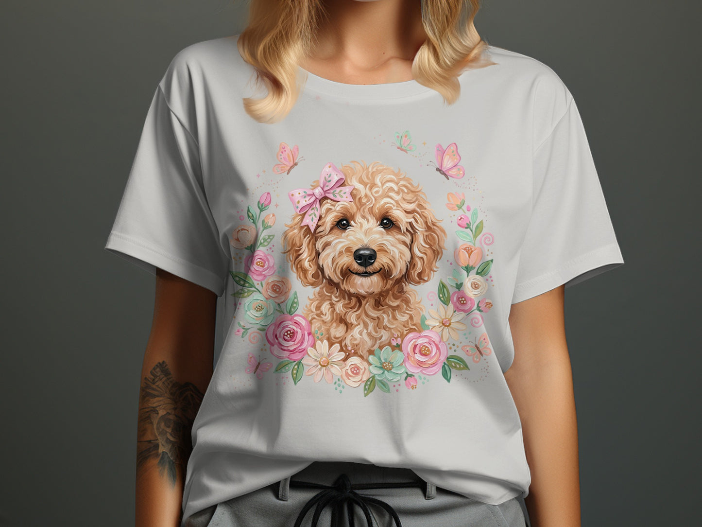 White t-shirt featuring a cartoon dog wearing a bow, surrounded by flowers and butterflies.
