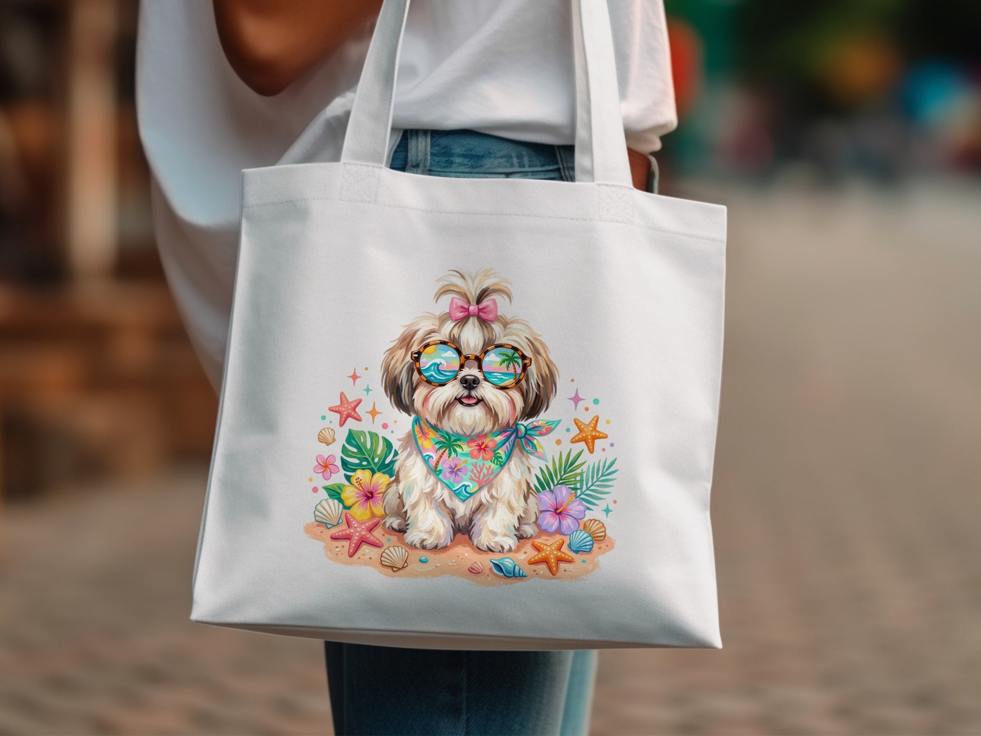 White tote bag with a cartoon shih tzu wearing sunglasses and a bandana, surrounded by shells and flowers.