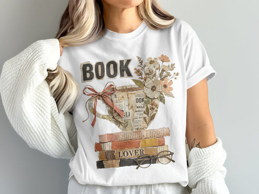 T-shirt with "BOOK LOVER" design featuring a teacup filled with books and flowers.
