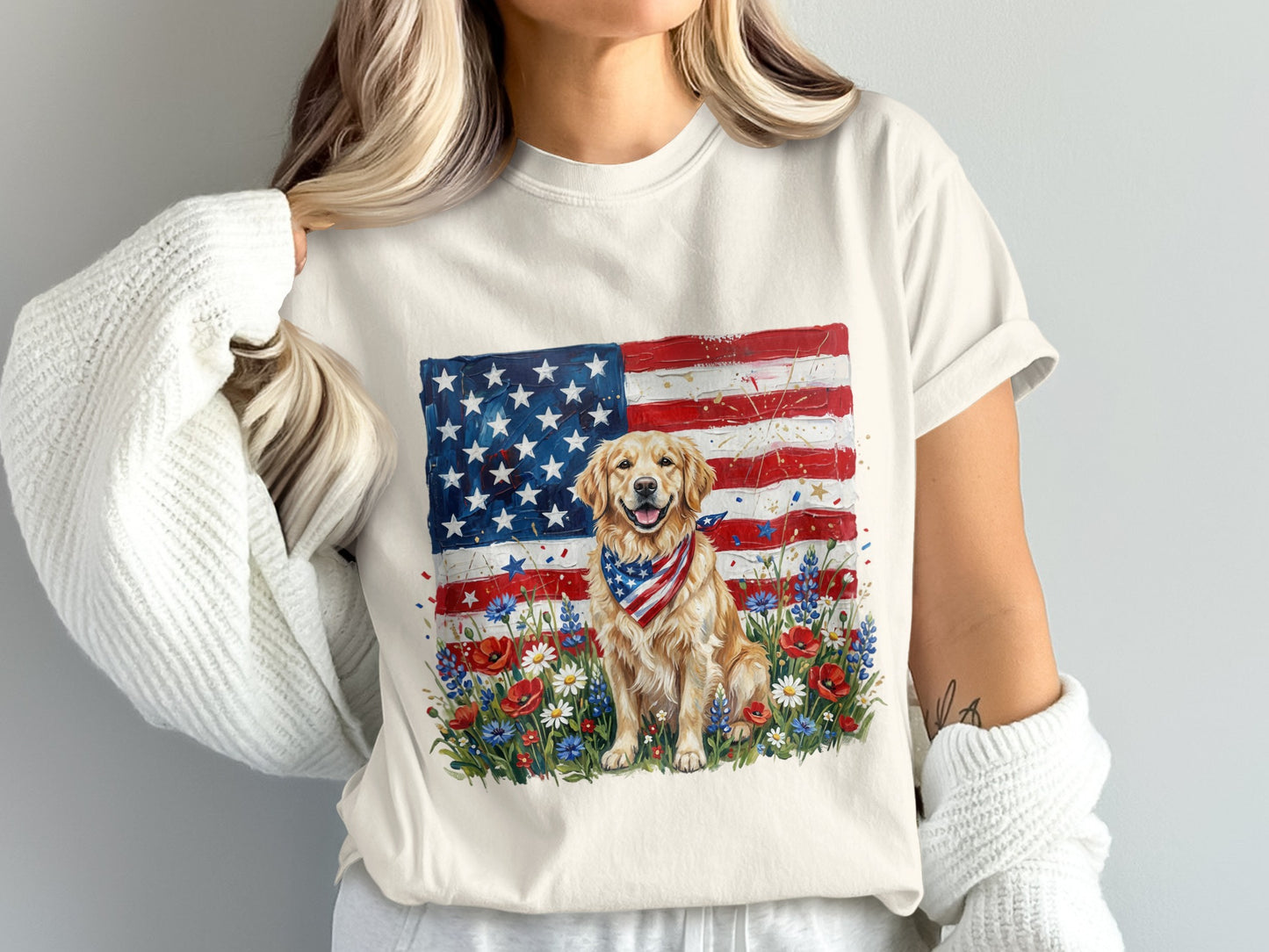 Golden retriever wearing bandana sits in front of American flag and wildflowers.