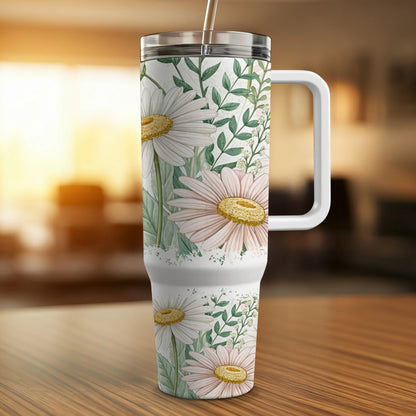 White tumbler with daisies and green leaves pattern, silver straw.