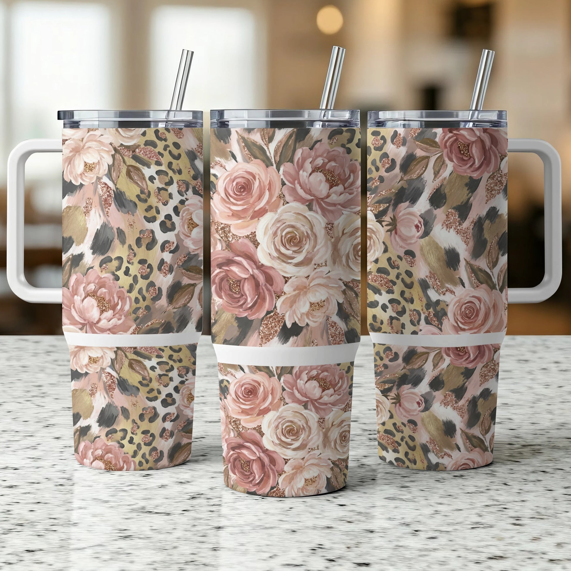Three stainless steel tumblers with floral and leopard print designs.