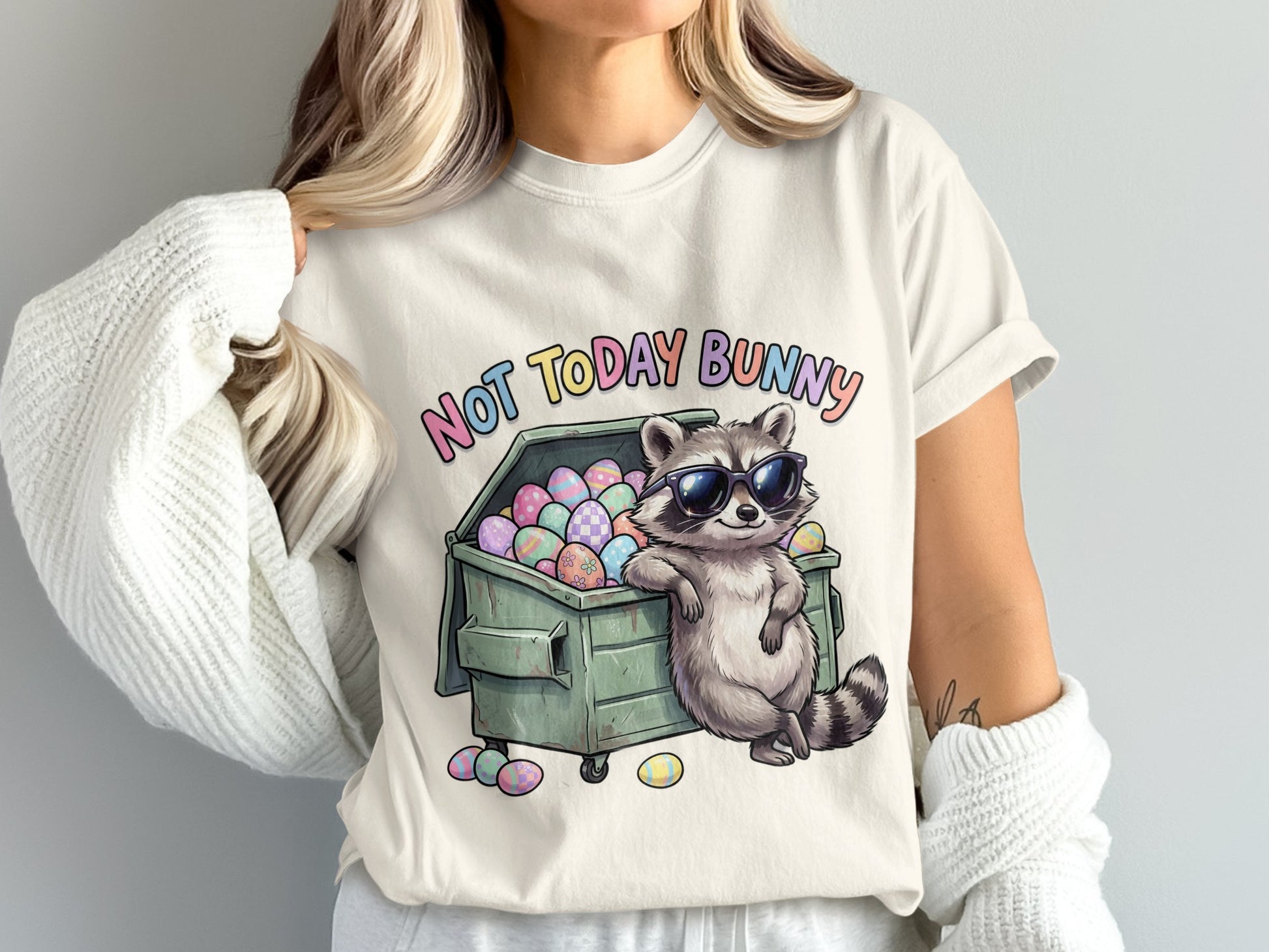 Raccoon in sunglasses leaning on dumpster full of colorful Easter eggs.