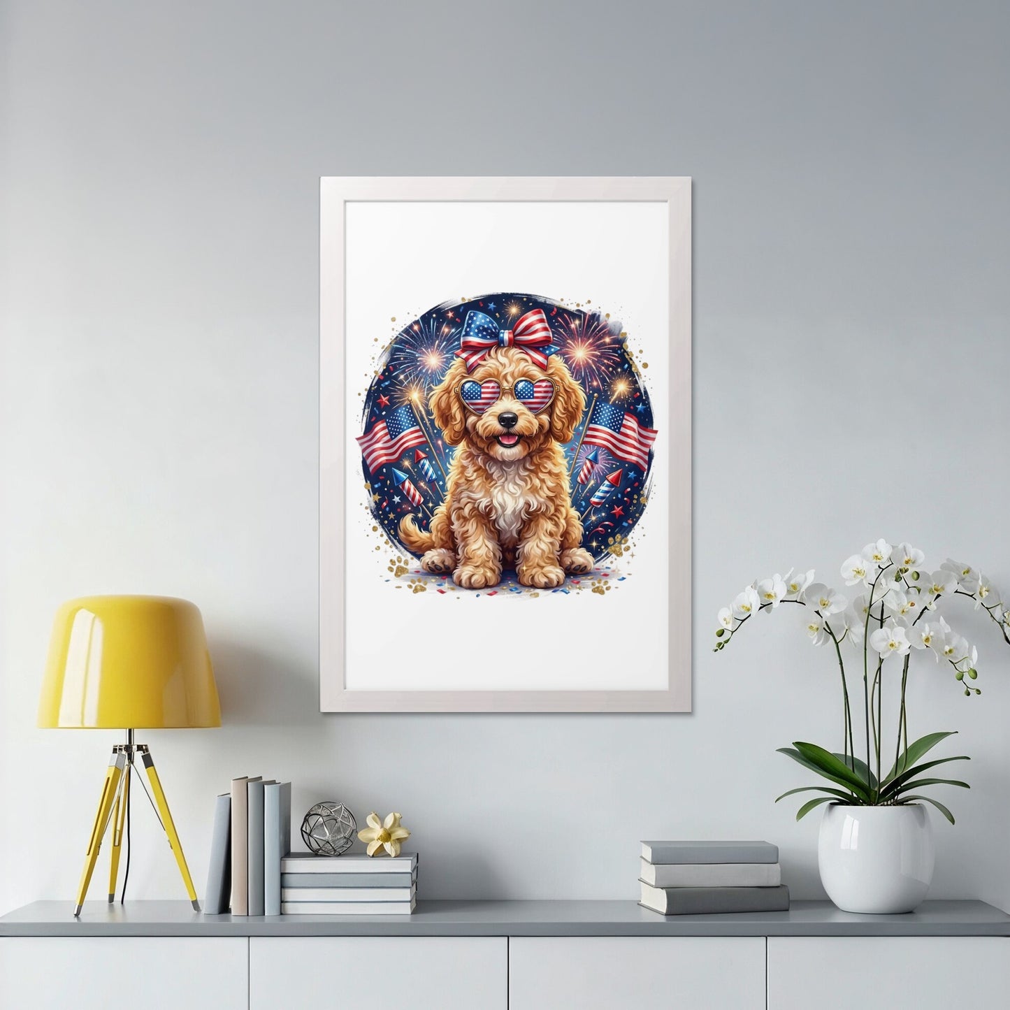 Golden doodle wearing patriotic sunglasses and bow, sitting in front of fireworks.