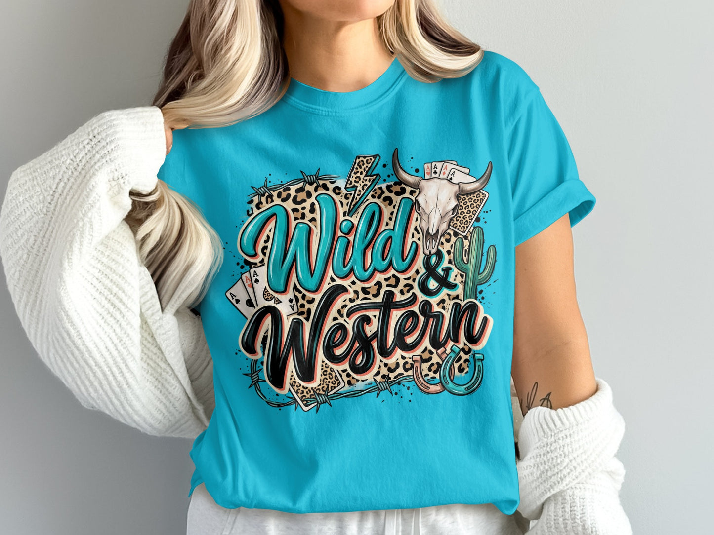 Turquoise t-shirt with "Wild & Western" text, bull skull, cards, and horseshoe graphic.