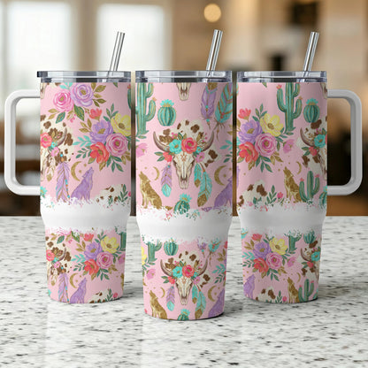 Pink tumbler with floral, cactus, wolf, and bull skull design.