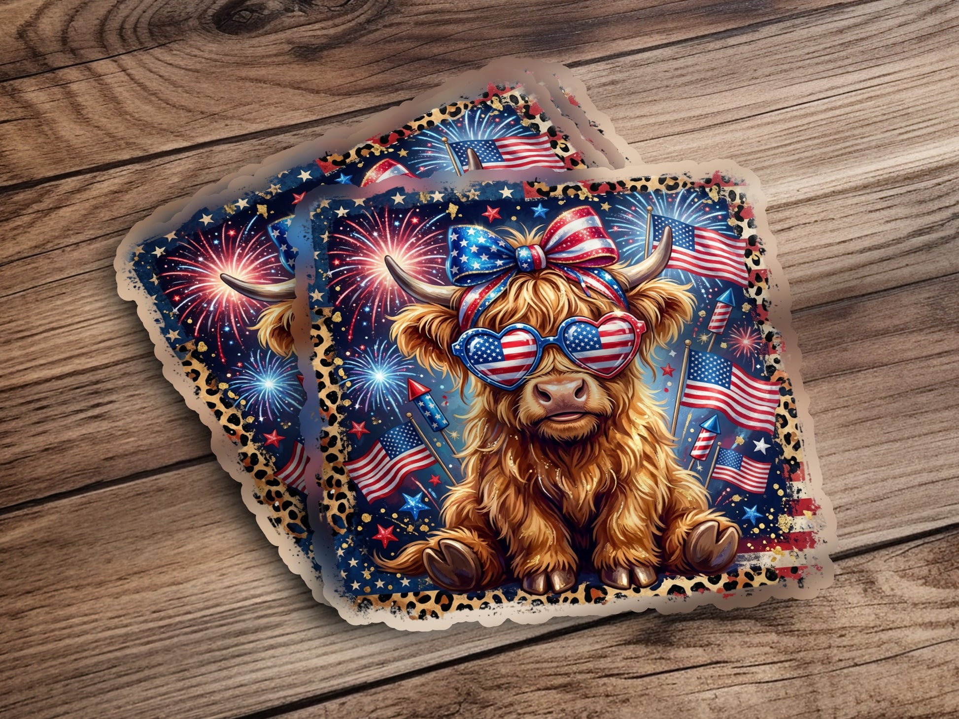 Highland cow wearing heart-shaped sunglasses with American flags and fireworks.