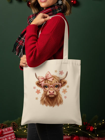 Tote bag featuring a Highland cow with pink glasses and bow.