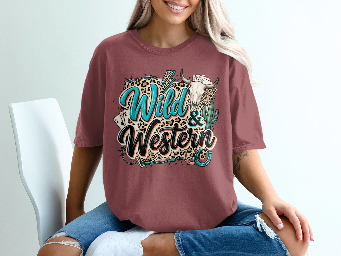 Woman wearing a maroon t-shirt with "Wild & Western" graphic.