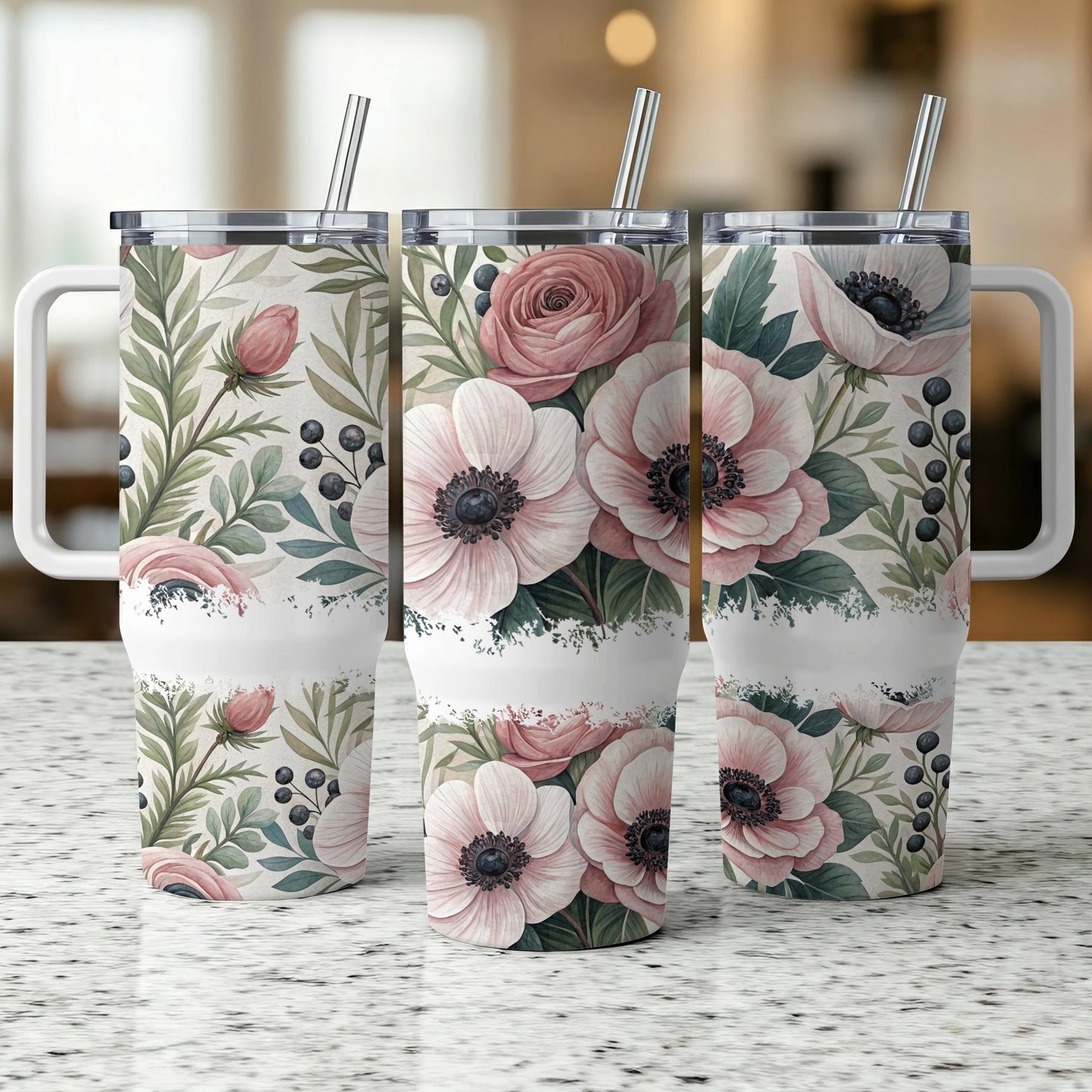 Three tumblers with floral and berry design, on a speckled countertop.