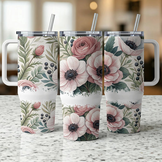 Three tumblers with floral and berry design, on a speckled countertop.