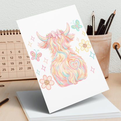 Watercolor highland cow with butterflies and flowers, pastel colors.
