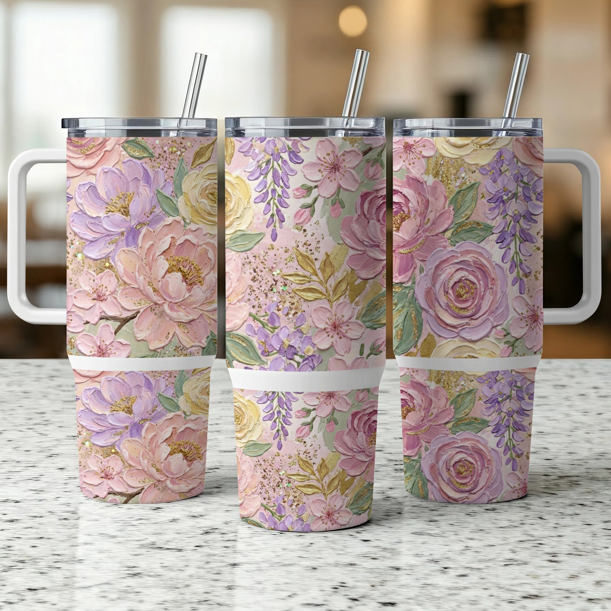 Three tumblers with floral patterns of pink, purple, and yellow flowers and green leaves.