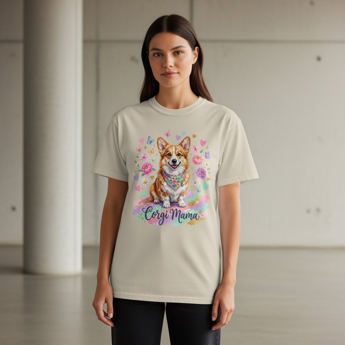Woman wearing a cream t-shirt with a watercolor corgi and floral design, "Corgi Mama" text.