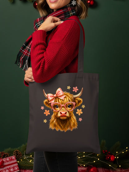 Tote bag with a Highland cow wearing glasses and a bow, surrounded by flowers.