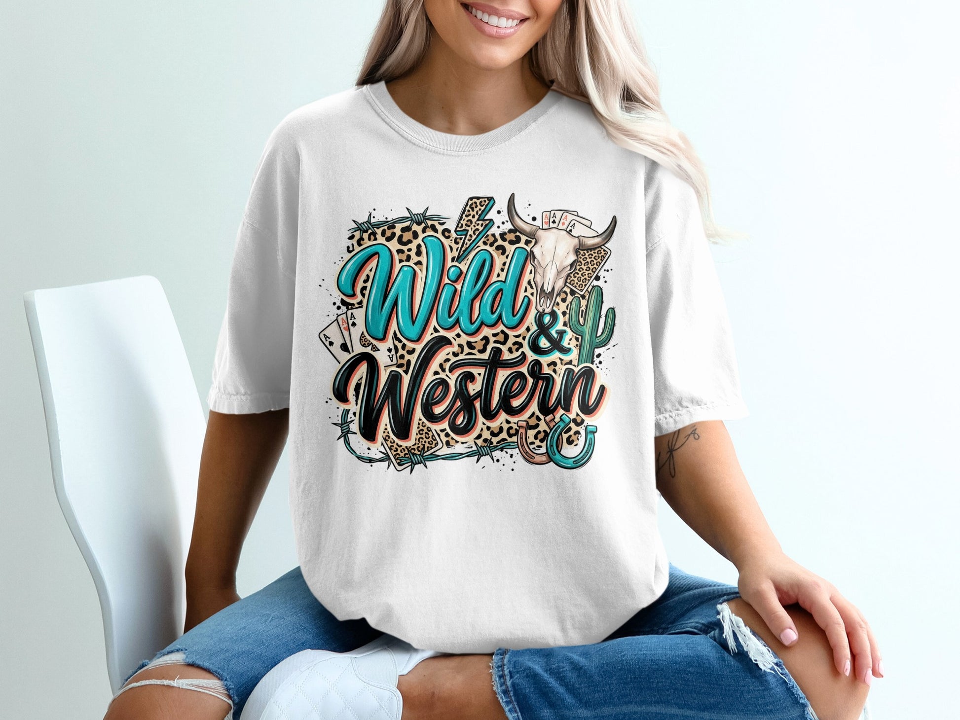 White t-shirt with "Wild & Western" text, cactus, bull skull, and playing cards.