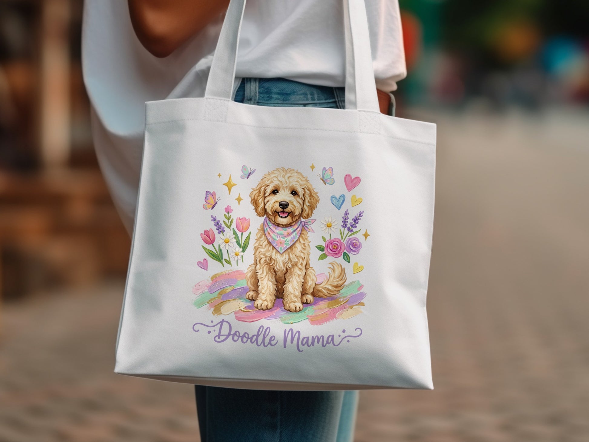 White tote bag with a cartoon doodle dog wearing a bandana, surrounded by flowers and butterflies.