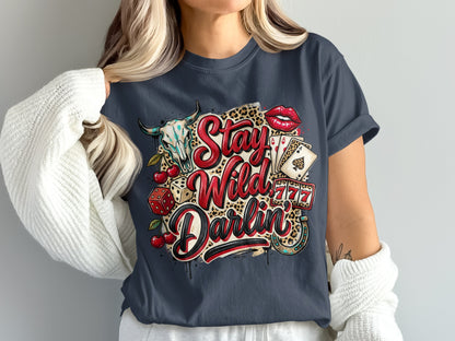 T-shirt with "Stay Wild Darlin'" text, bull skull, dice, cherries, lips, playing cards, and horseshoe.