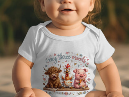 Baby wearing white bodysuit with "my three moods" and farm animals illustration.