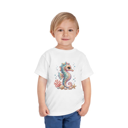 White t-shirt with cartoon seahorse, coral, and seashells illustration.