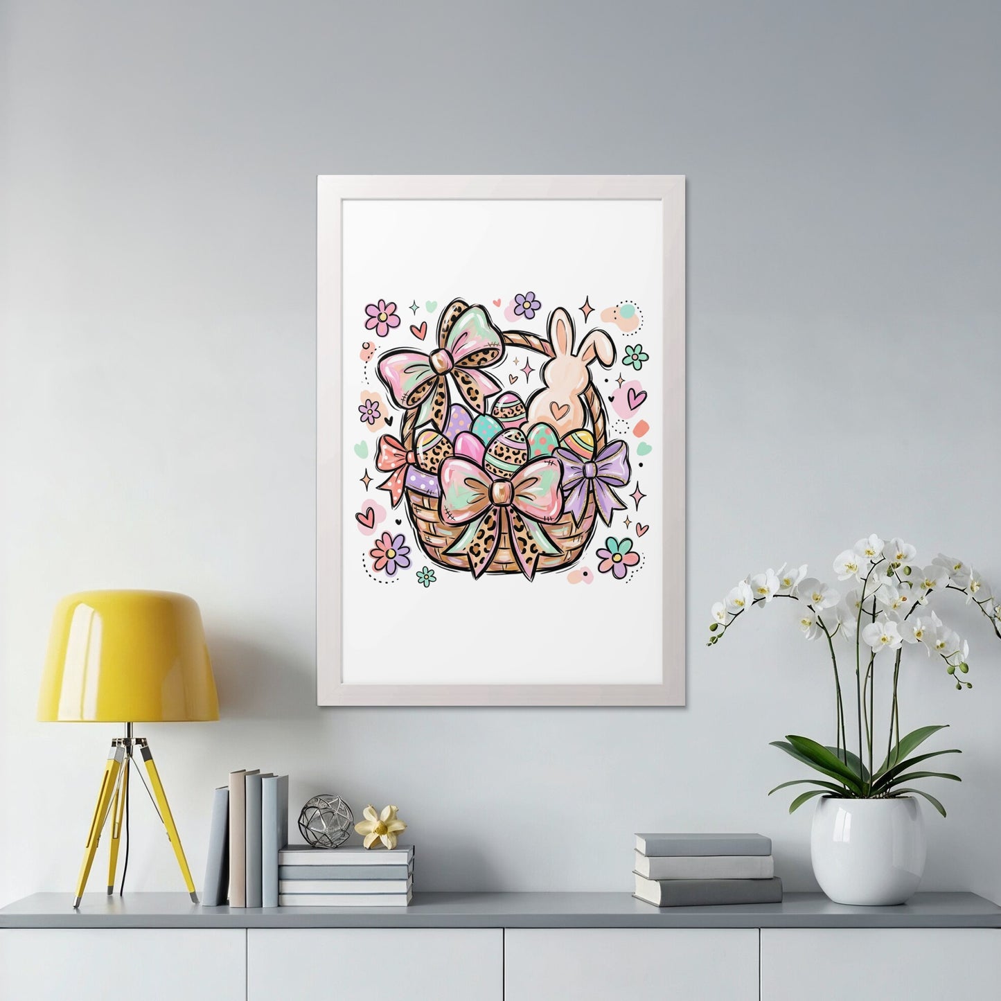 Easter basket filled with colorful eggs, a bunny, and bows in a white frame.
