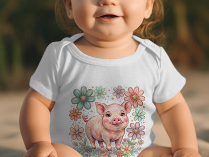 Baby wearing white onesie with smiling pig and floral design.