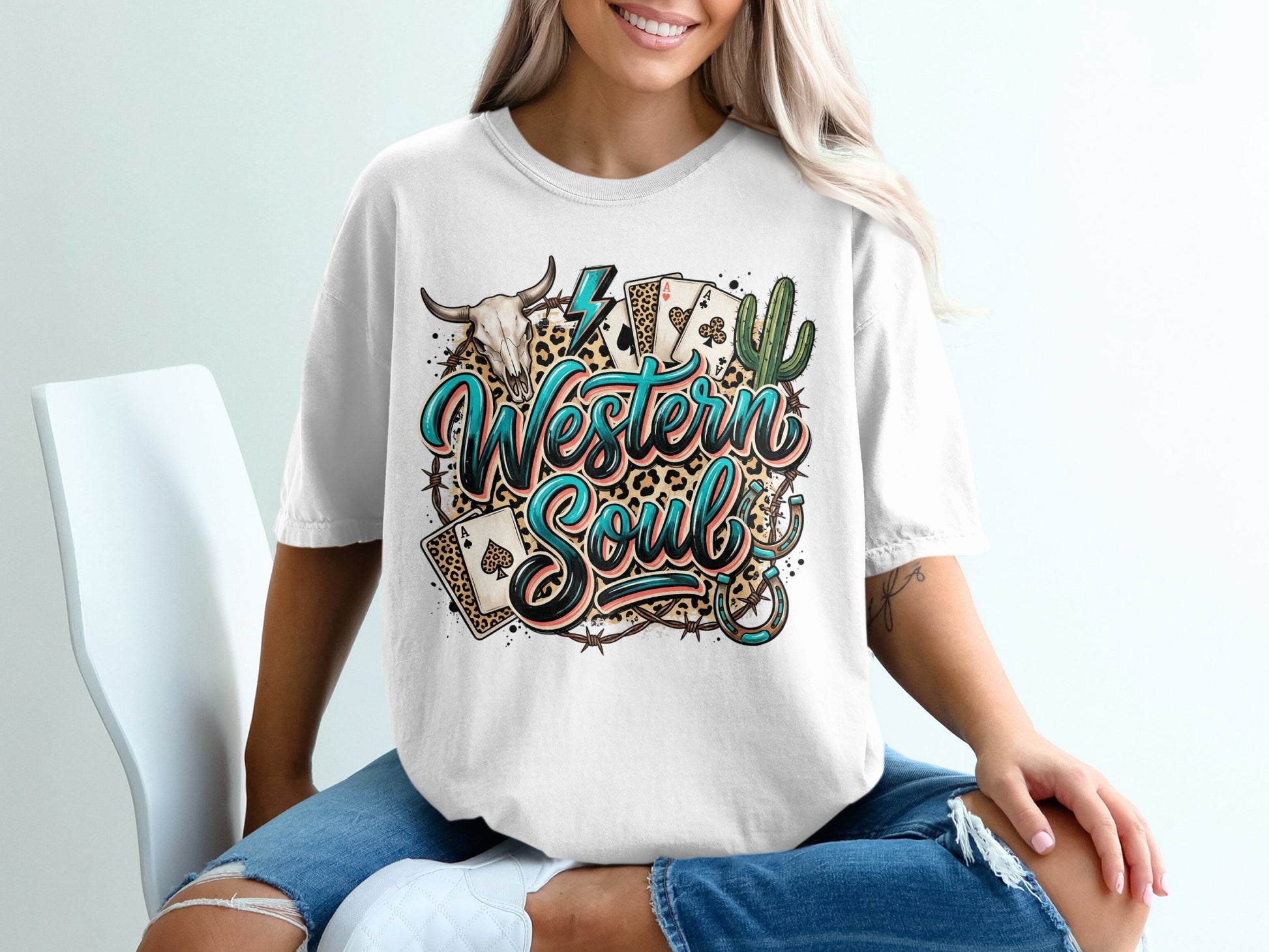 White t-shirt with "Western Soul" text, playing cards, bull skull, and cactus.