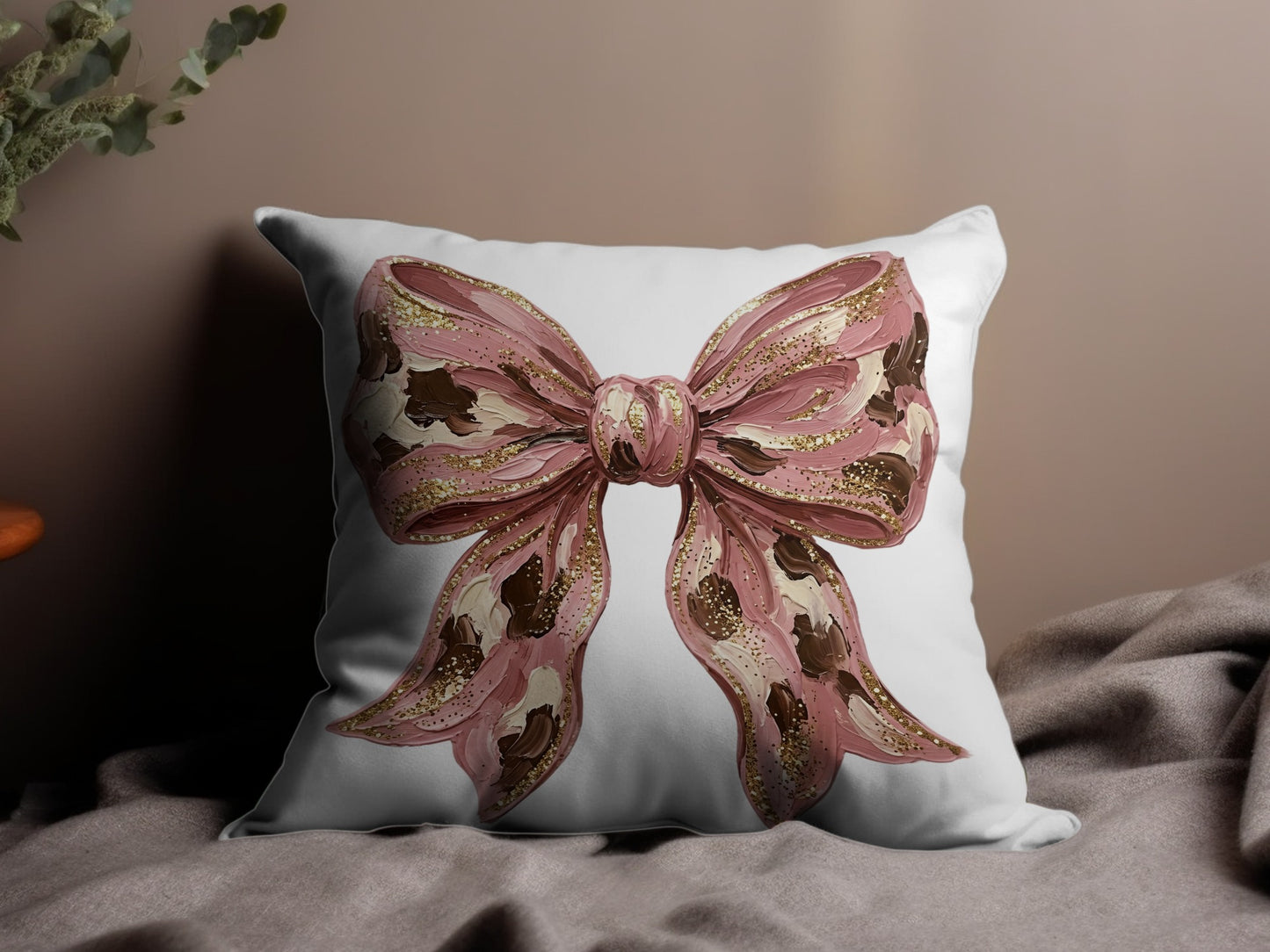 Pink bow graphic on a white throw pillow with textured details.
