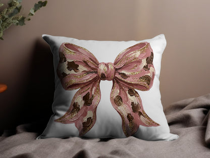 Pink bow graphic on a white throw pillow with textured details.