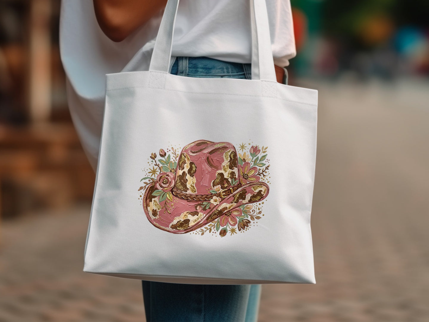 White tote bag with a pink floral cowboy hat design.