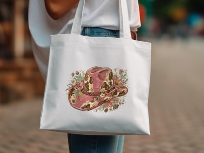 White tote bag with a pink floral cowboy hat design.