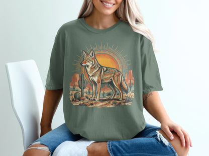Green t-shirt with coyote and desert scene illustration.