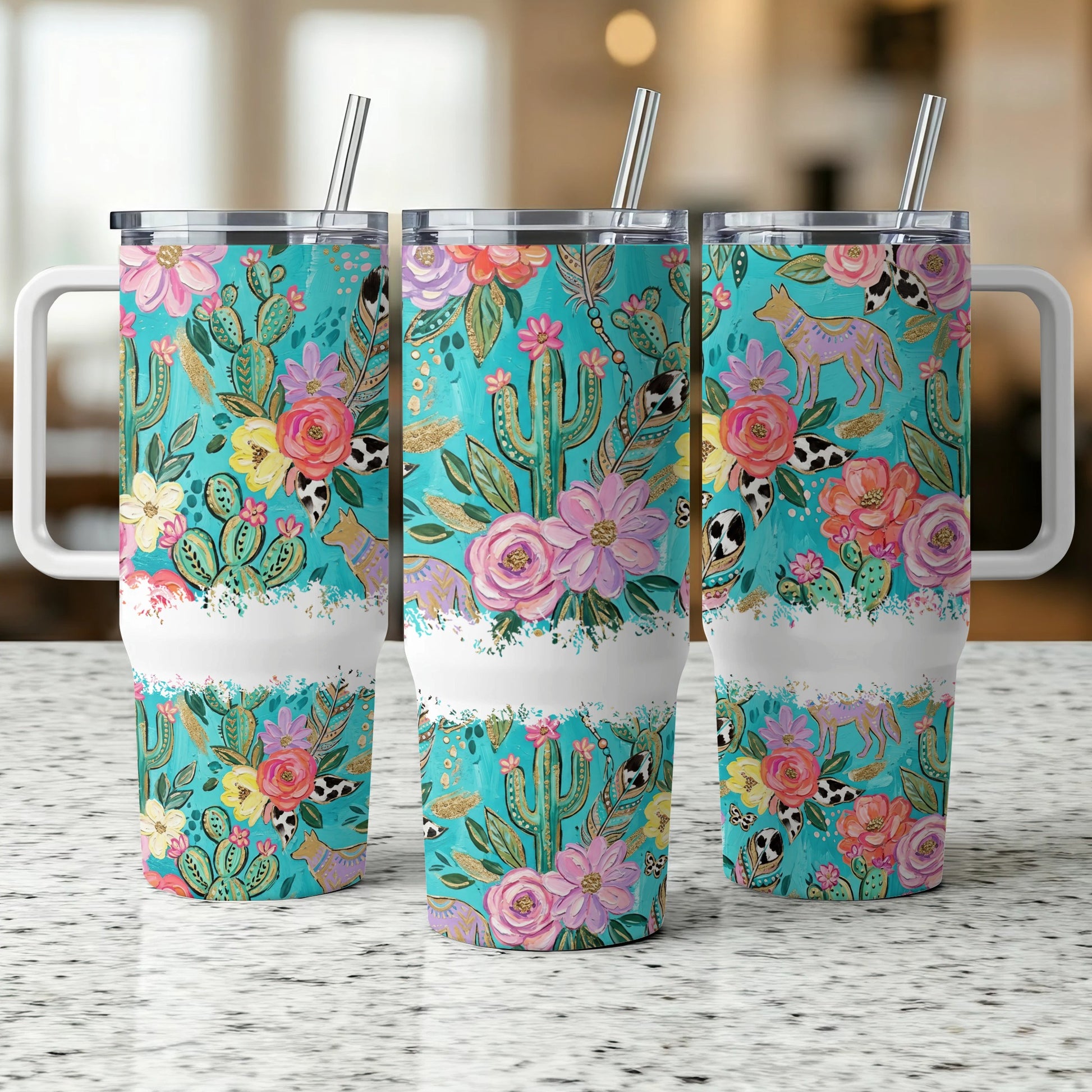 Three tumblers with desert floral and animal pattern on a speckled counter.