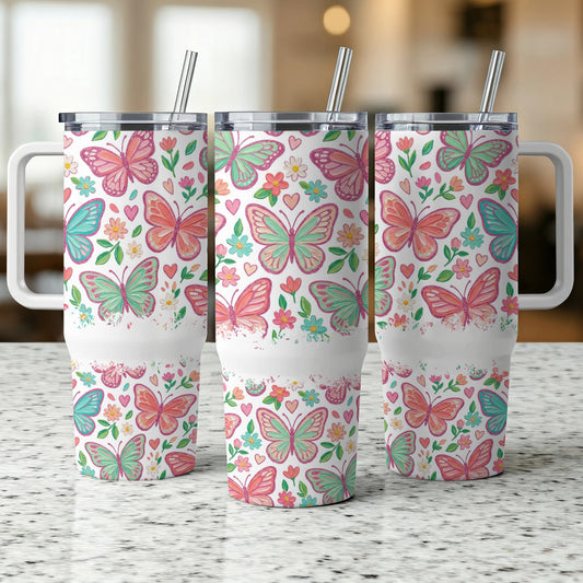 Three insulated tumblers with pink and green butterflies and floral patterns.