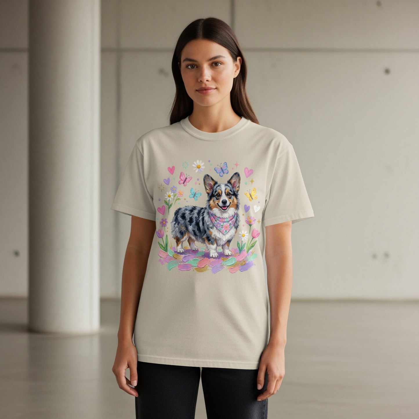Beige t-shirt with a corgi dog wearing a bandana and surrounded by butterflies and flowers.