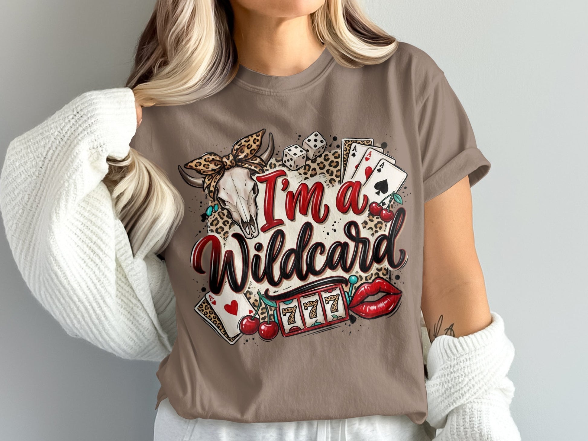 Brown t-shirt with "I'm a Wildcard" text, skull, dice, cherries, slot machine, and lips.