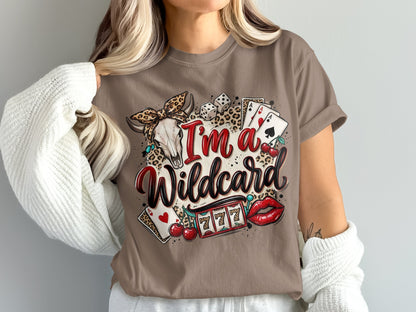 Brown t-shirt with "I'm a Wildcard" text, skull, dice, cherries, slot machine, and lips.