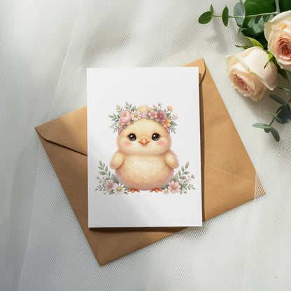 Fluffy chick wearing a floral crown on a card with a brown envelope.