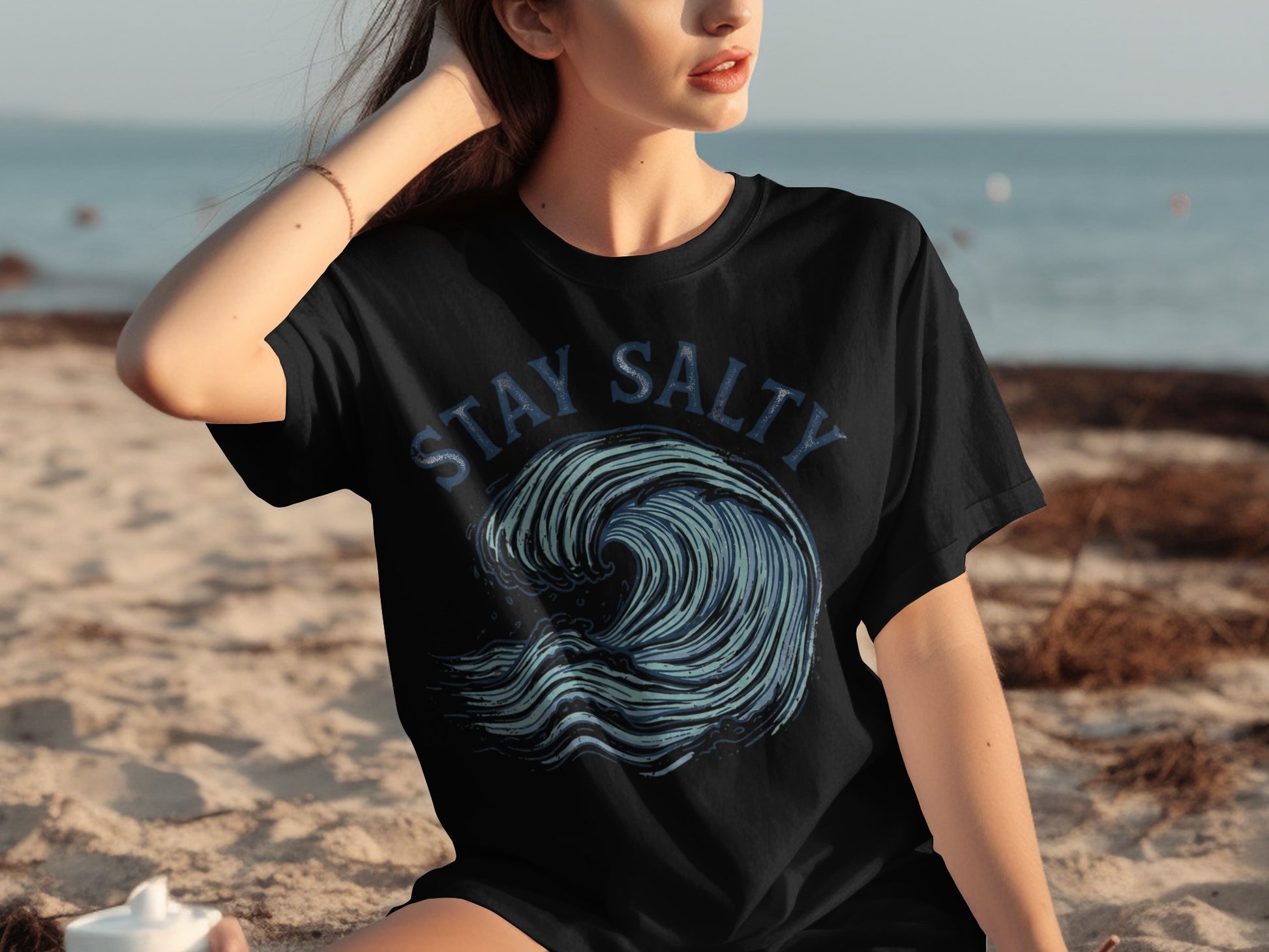 Black t-shirt with blue "STAY SALTY" text over a stylized wave graphic.