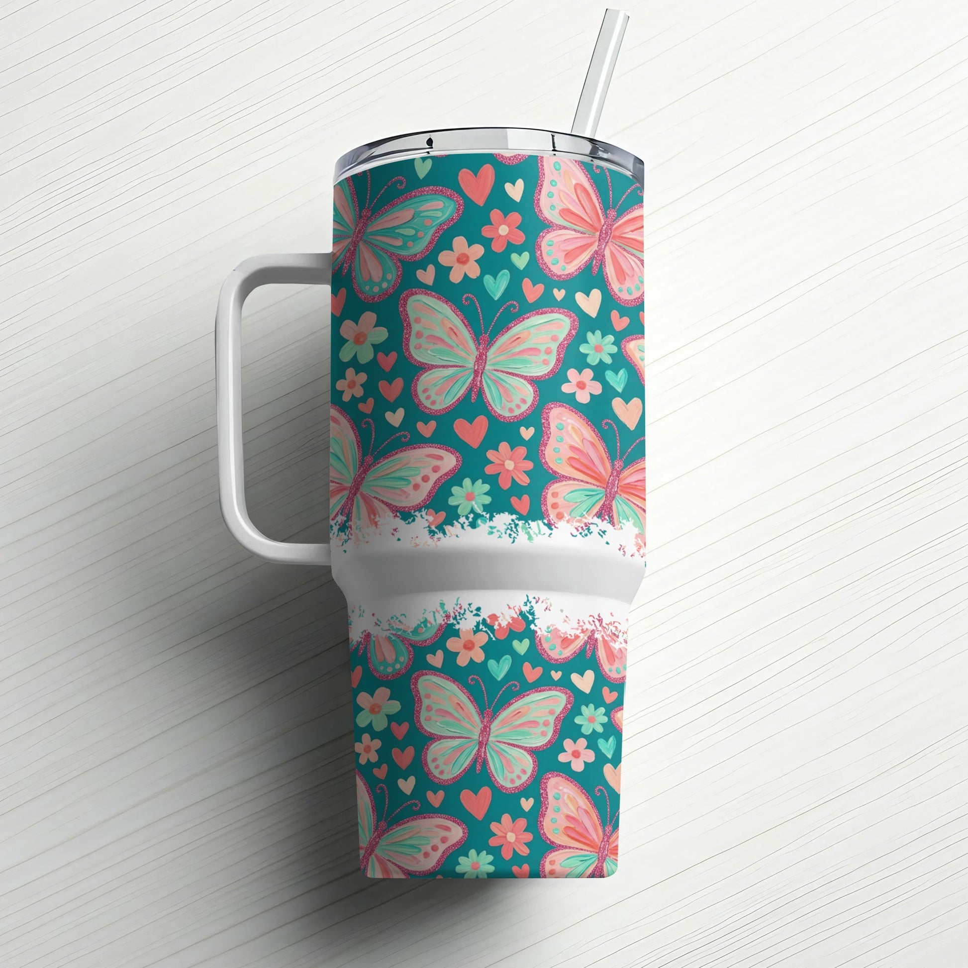 Teal tumbler with a repeating pattern of pink and coral butterflies and hearts.