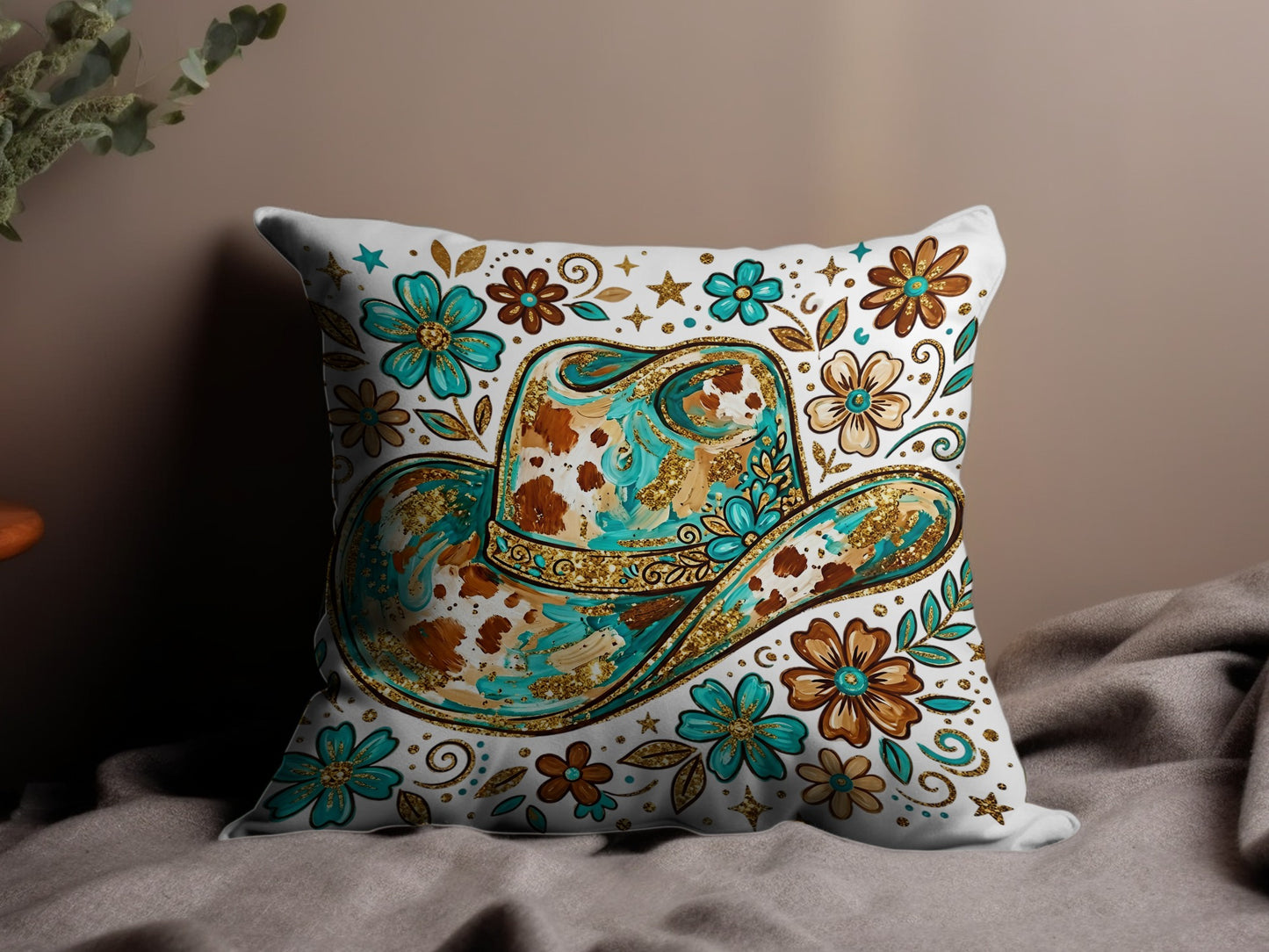 Western cowboy hat with floral and glitter design on a decorative pillow.