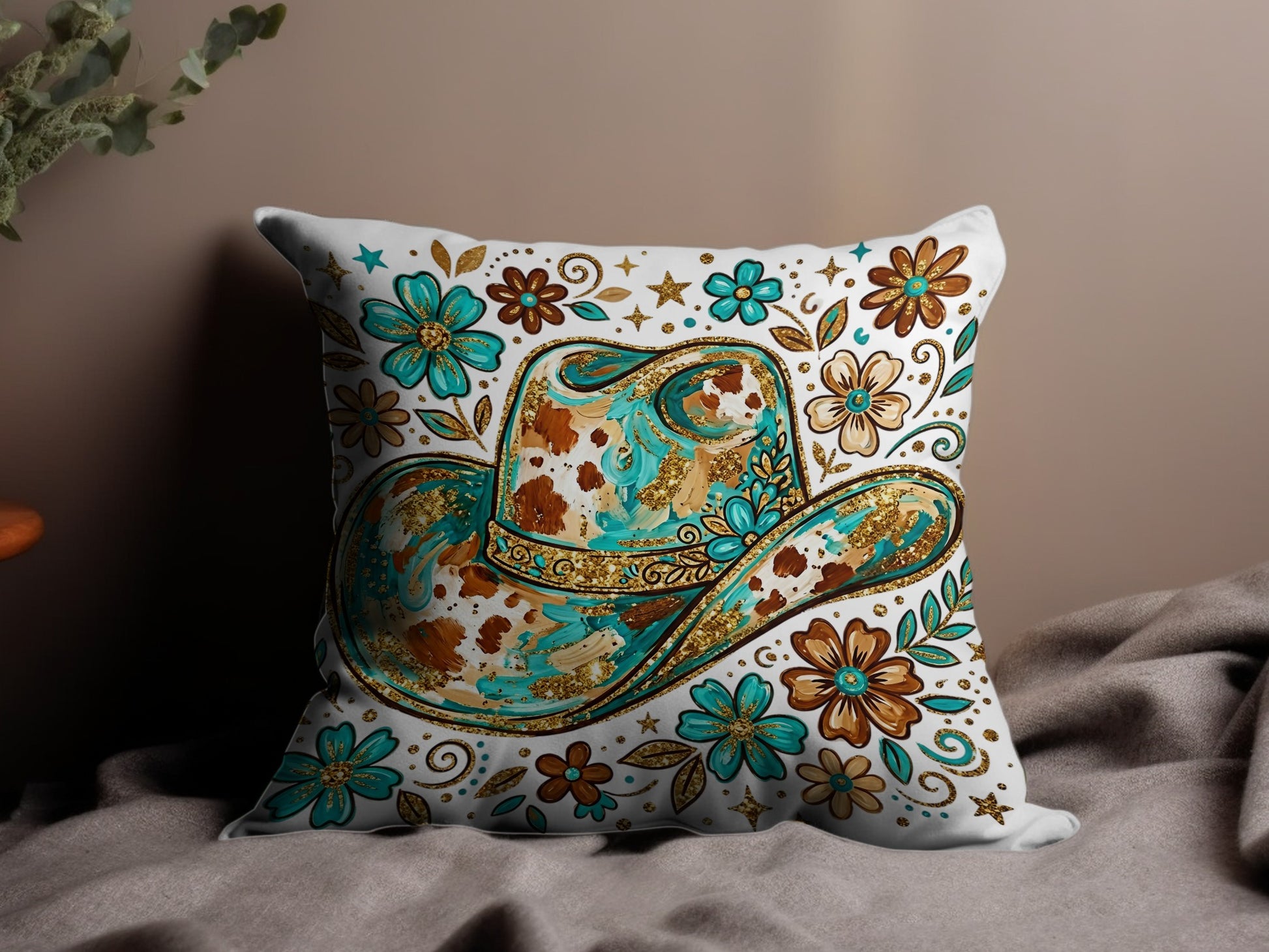 Western cowboy hat with floral and glitter design on a decorative pillow.