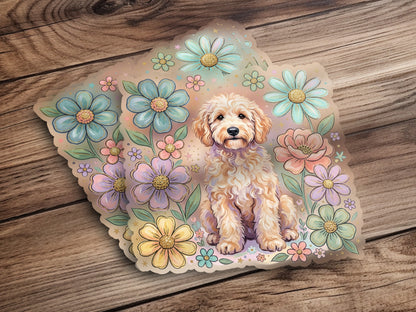Golden doodle dog sits among pastel flowers on a wooden background.
