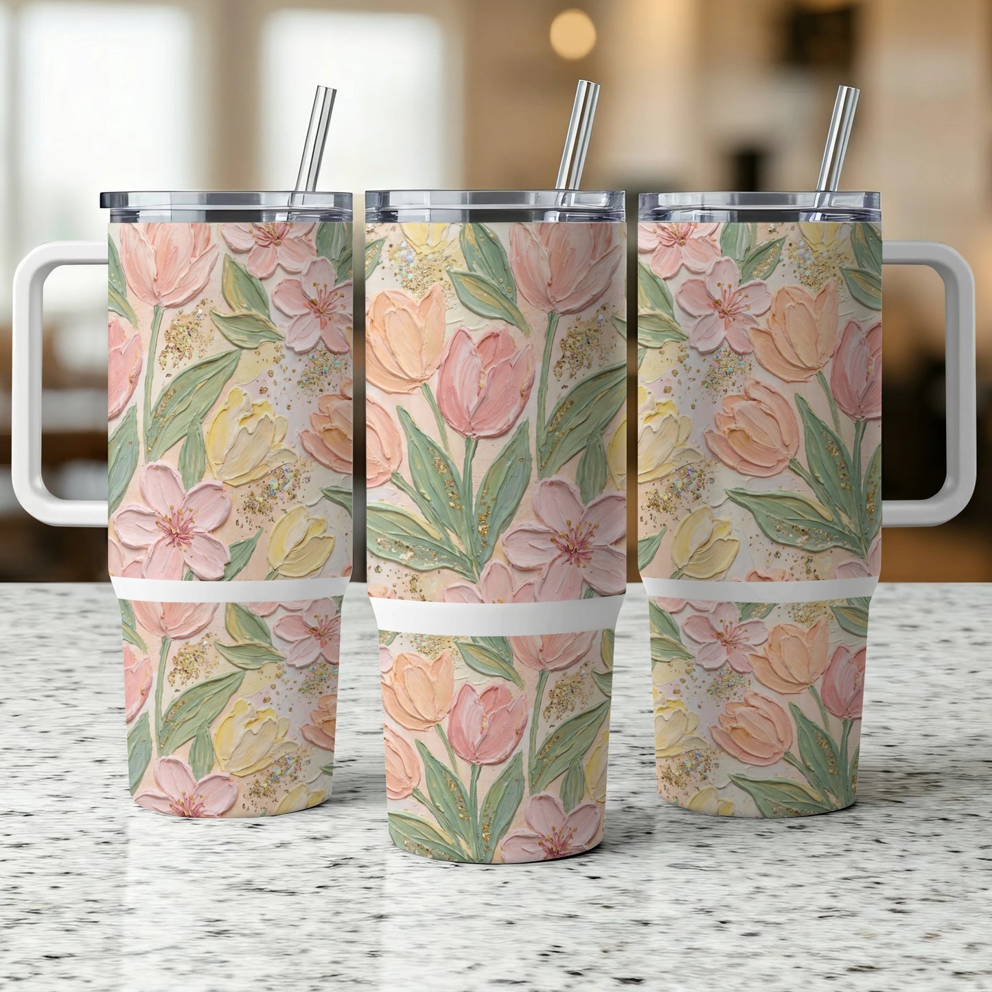 Three insulated tumblers with a floral pattern of pink and yellow tulips.