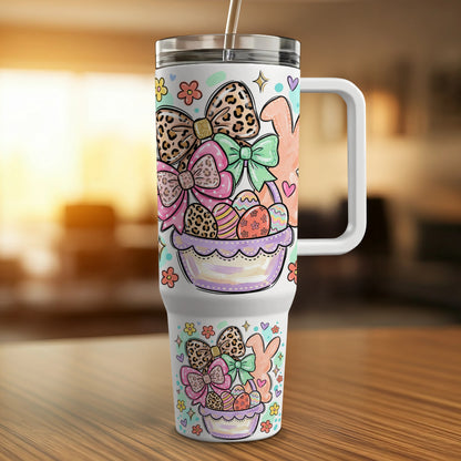 Easter basket with bows, eggs, and bunnies, on a patterned tumbler.